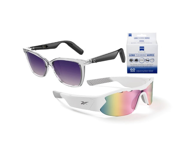 Two pairs of Lucyd MomPack sunglasses—one with clear frames and purple lenses, the other with white frames and rainbow-tinted lenses—are displayed alongside a box of Zeiss lens cleaning wipes from Lucyd Bundles.