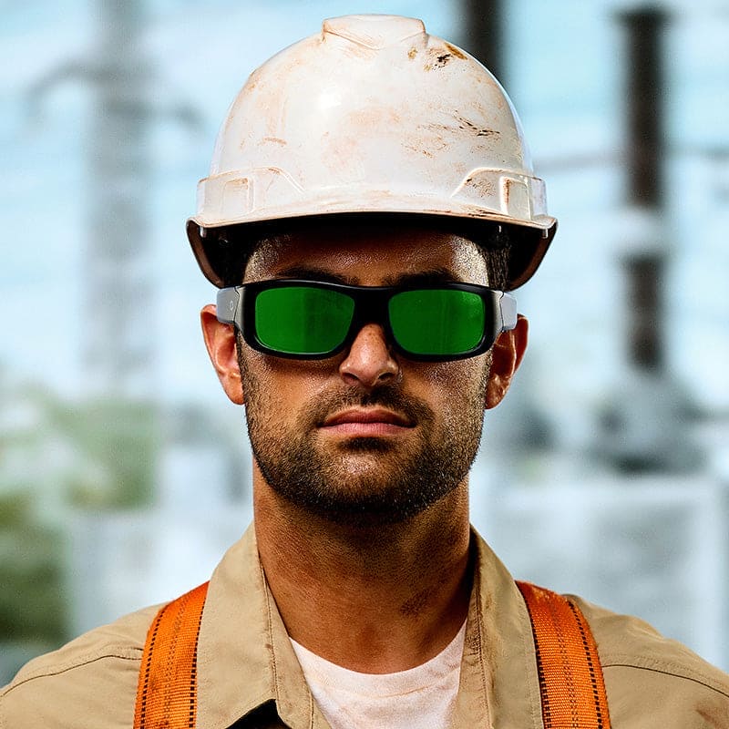 Construction worker wearing Lucyd Armor Green Mirror Polarized sunglasses with white hard hat outdoors