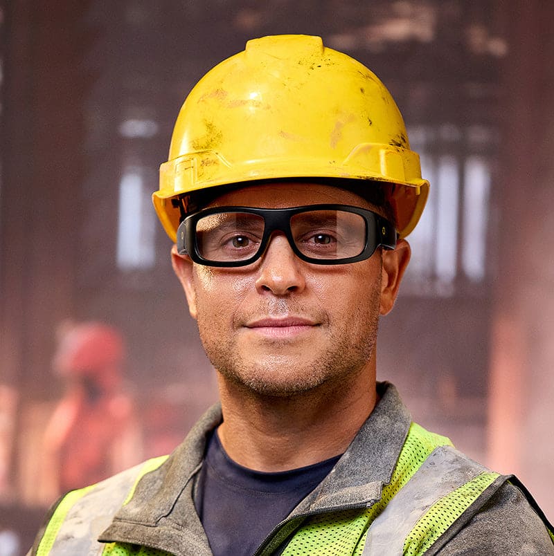 Construction worker wearing Lucyd Armor Photochromic safety glasses with hard hat and reflective vest
