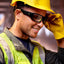 Construction worker wearing Lucyd Armor Photochromic Z87.1 safety glasses with yellow hard hat and reflective vest