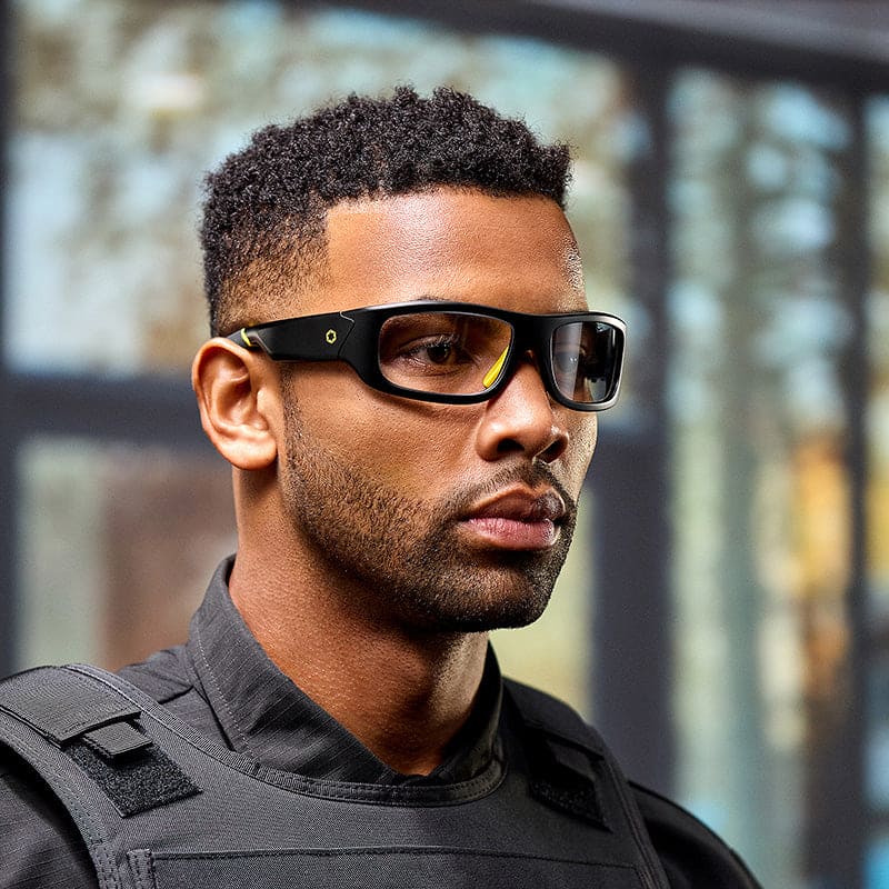 Man wearing Lucyd Armor Photochromic smart glasses with tactical vest
