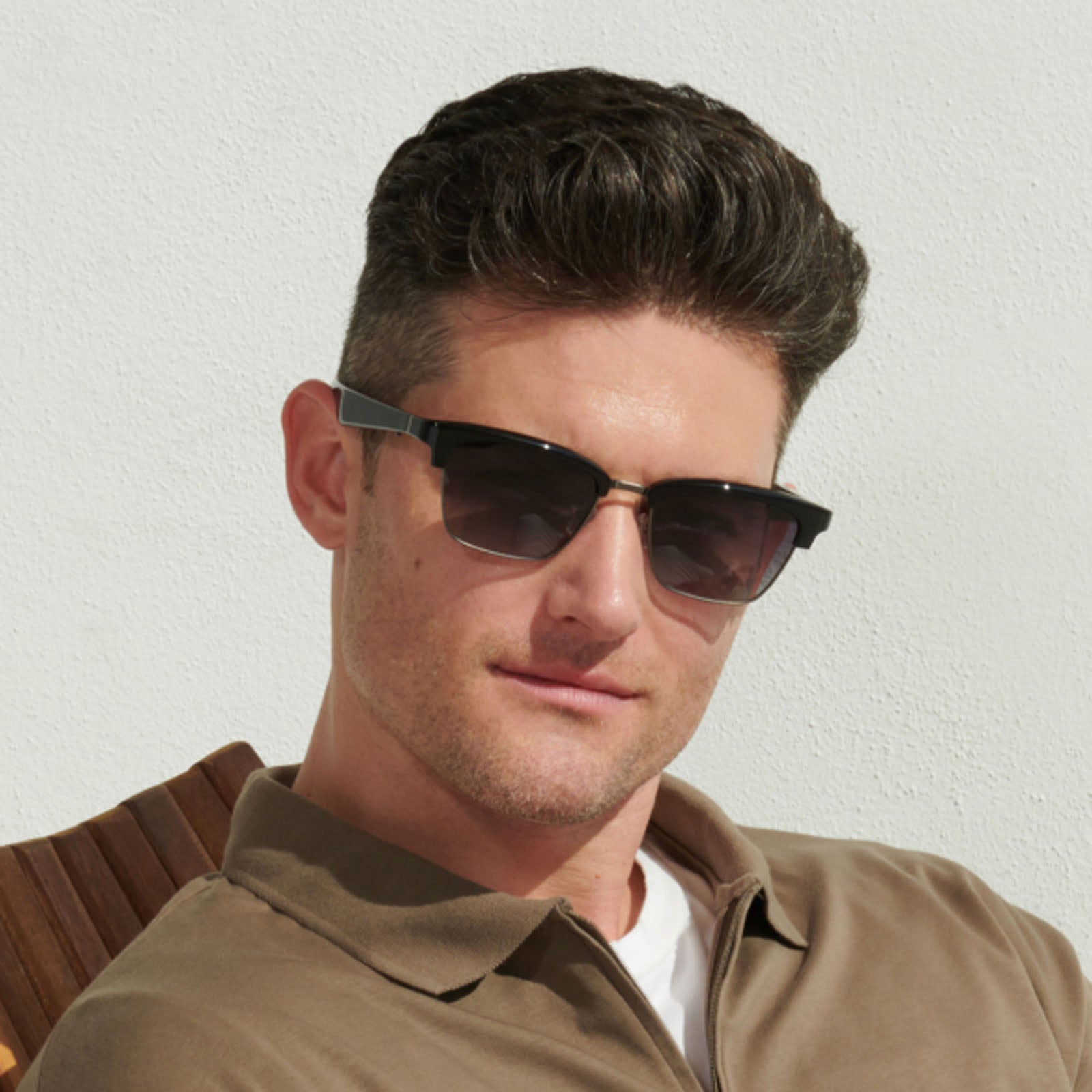 Lucyd Earthbound sunglasses are black, semi-rimless Bluetooth audio frames with thick arms and dark gradient lenses that provide UV protection, shown against a plain white background.