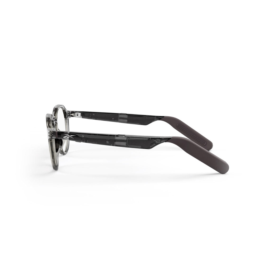 The Reebok Jet eyewear features transparent gray frames and solid dark-colored arms, emphasizing privacy-focused design. Shown from the side against a white background.