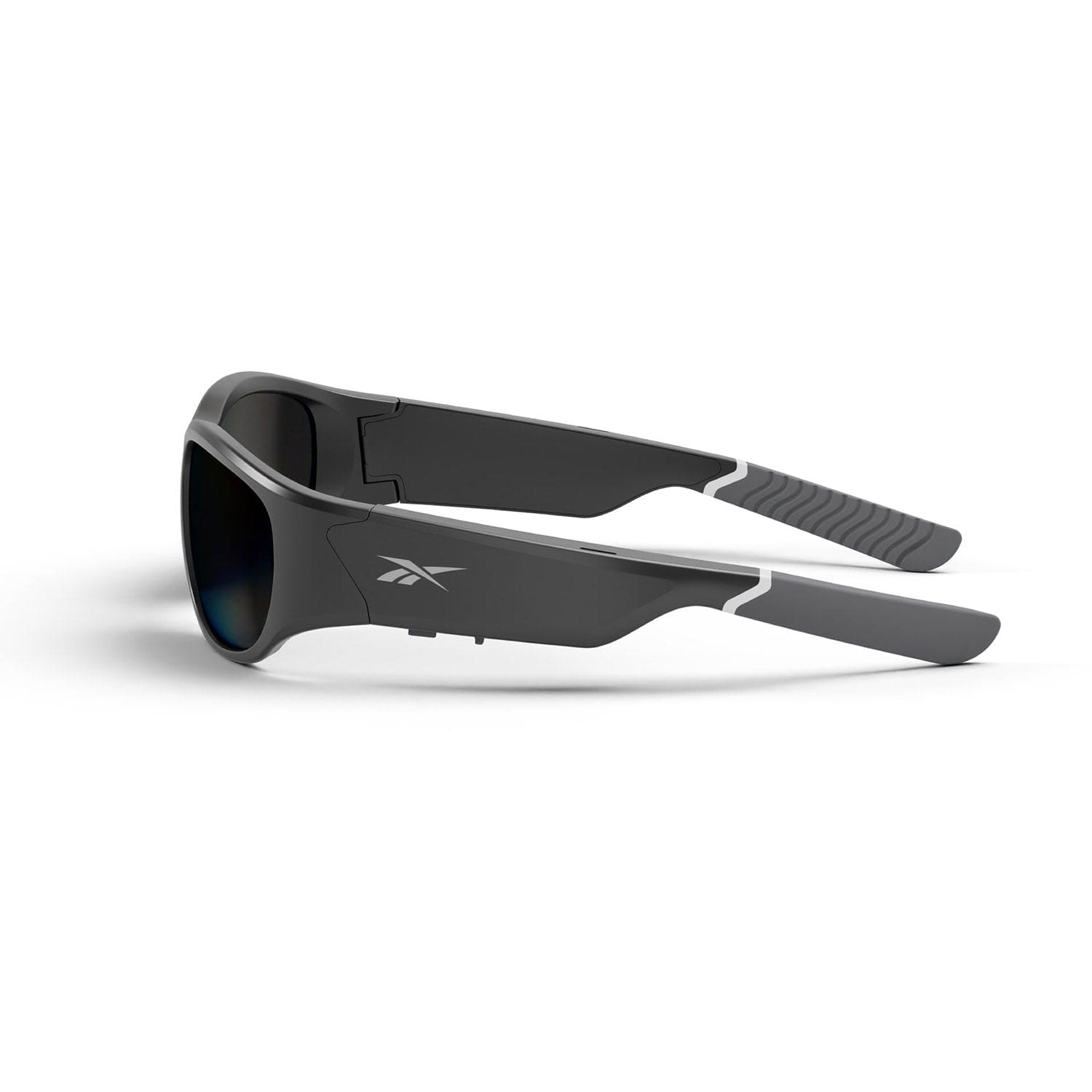 Reebok NITROUS: Black wraparound sunglasses with polarized lenses, thick angular arms featuring a small white Reebok logo, and textured grips at the ends for comfort. Set against a white background.