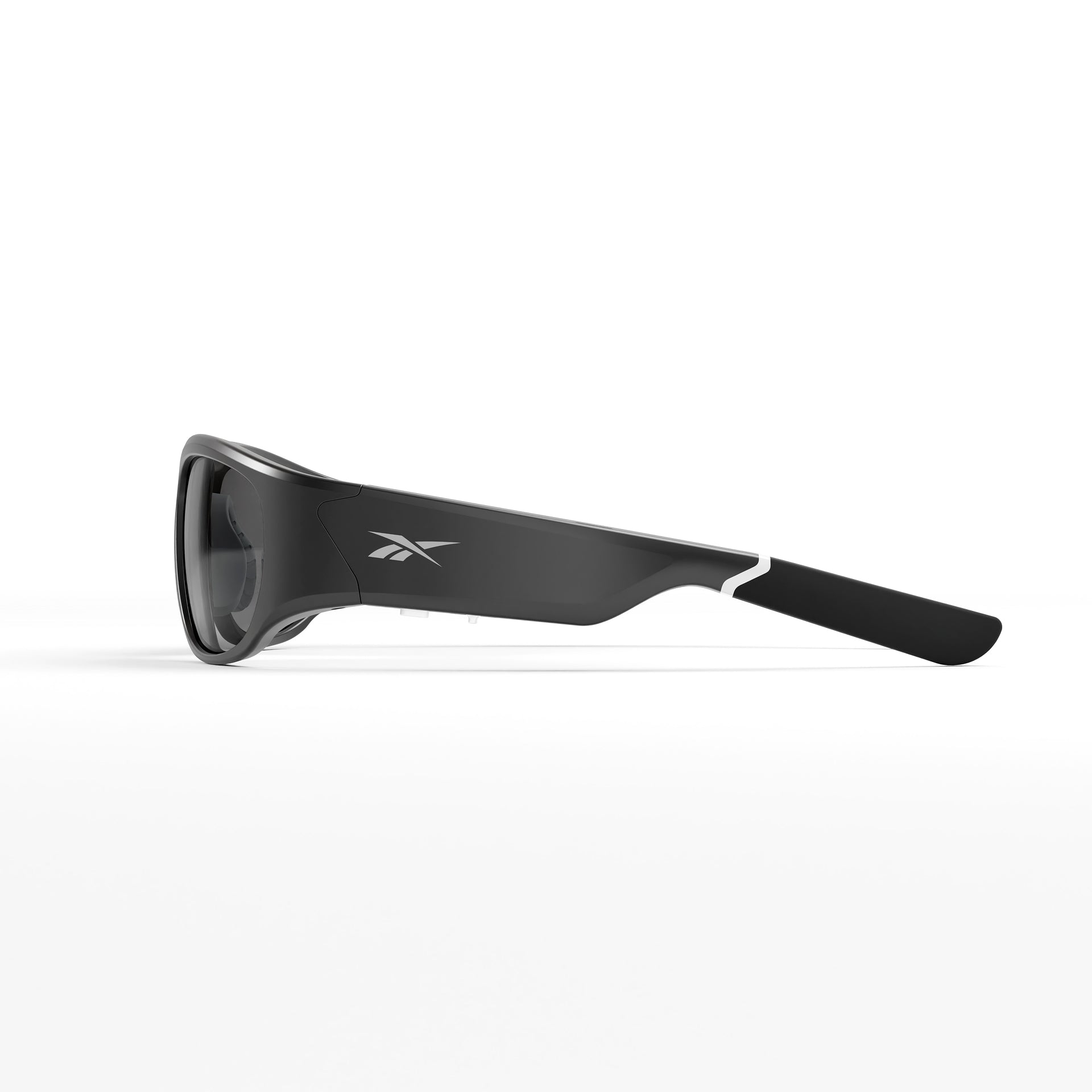 Side view of Nitrous Shift smart eyewear sunglasses by Reebok, featuring a sleek black frame with white accent, Reebok logo on the arm, and adaptive photochromic lenses, shown against a plain white background.