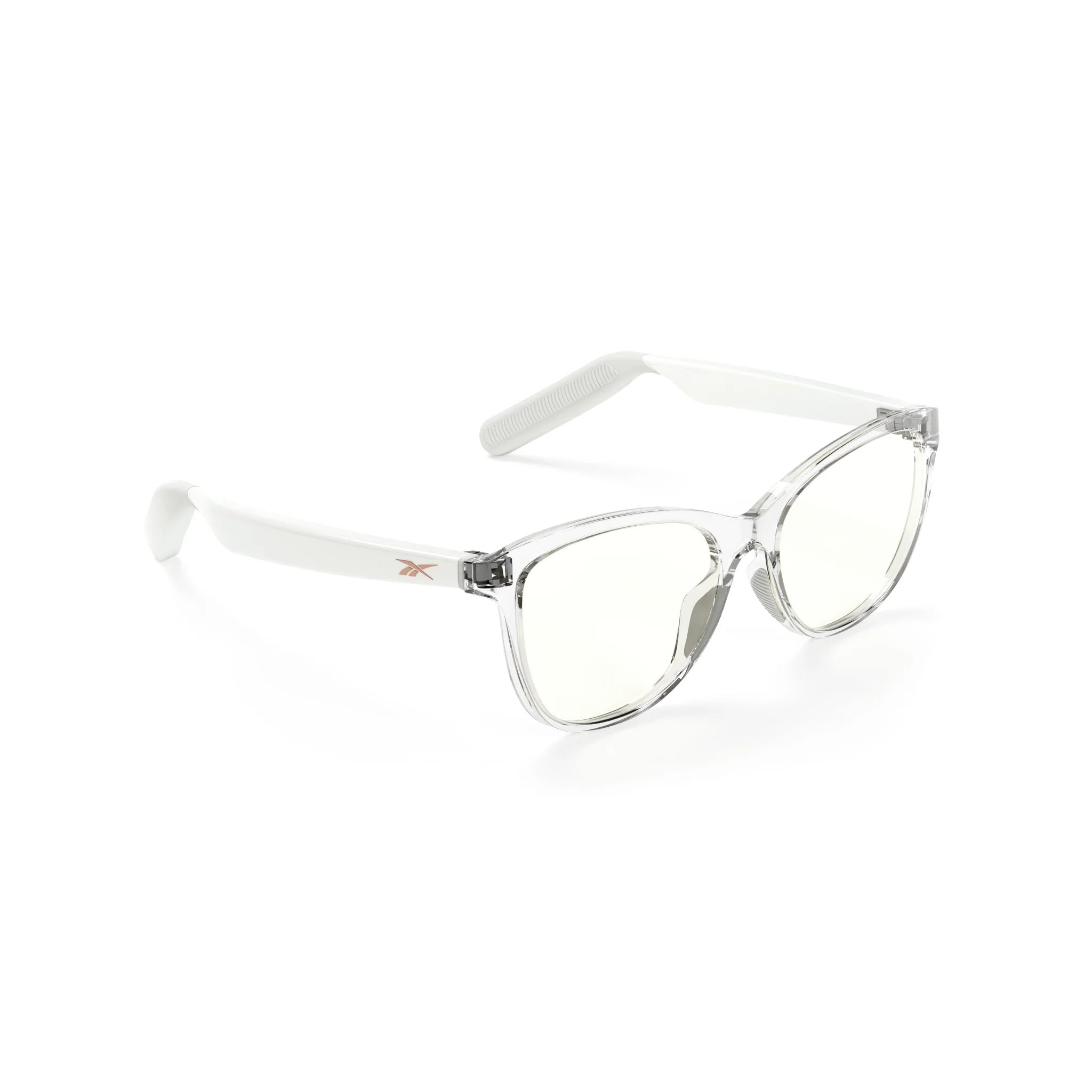 The Reebok Shine smart eyewear features clear frames, slightly tinted lenses, and white arms with open-ear audio. Displayed at a three-quarter angle on a white background.