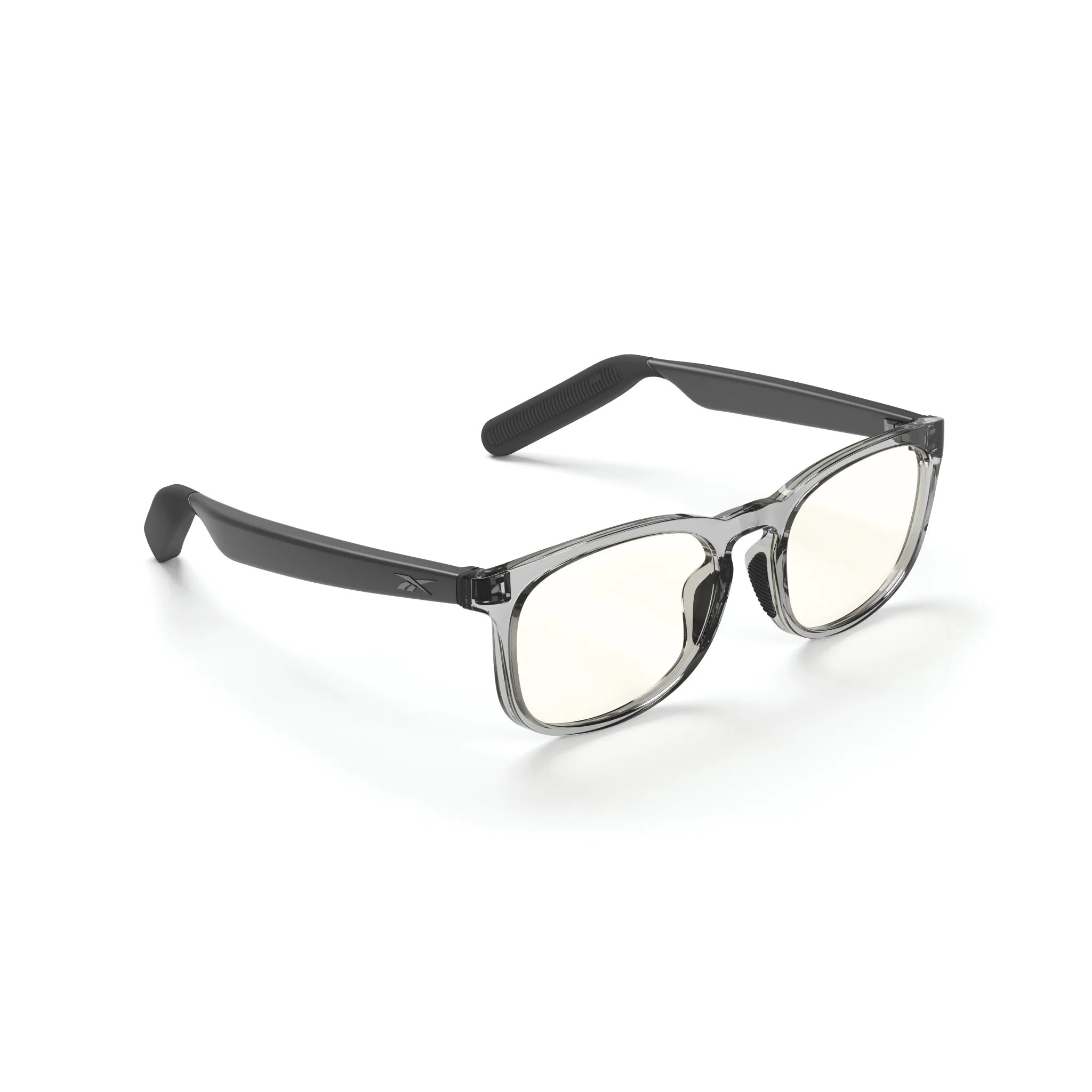 Reebok Thunder smart glasses with clear frames, slightly tinted lenses, black arms, and open-ear audio are displayed on a white background.