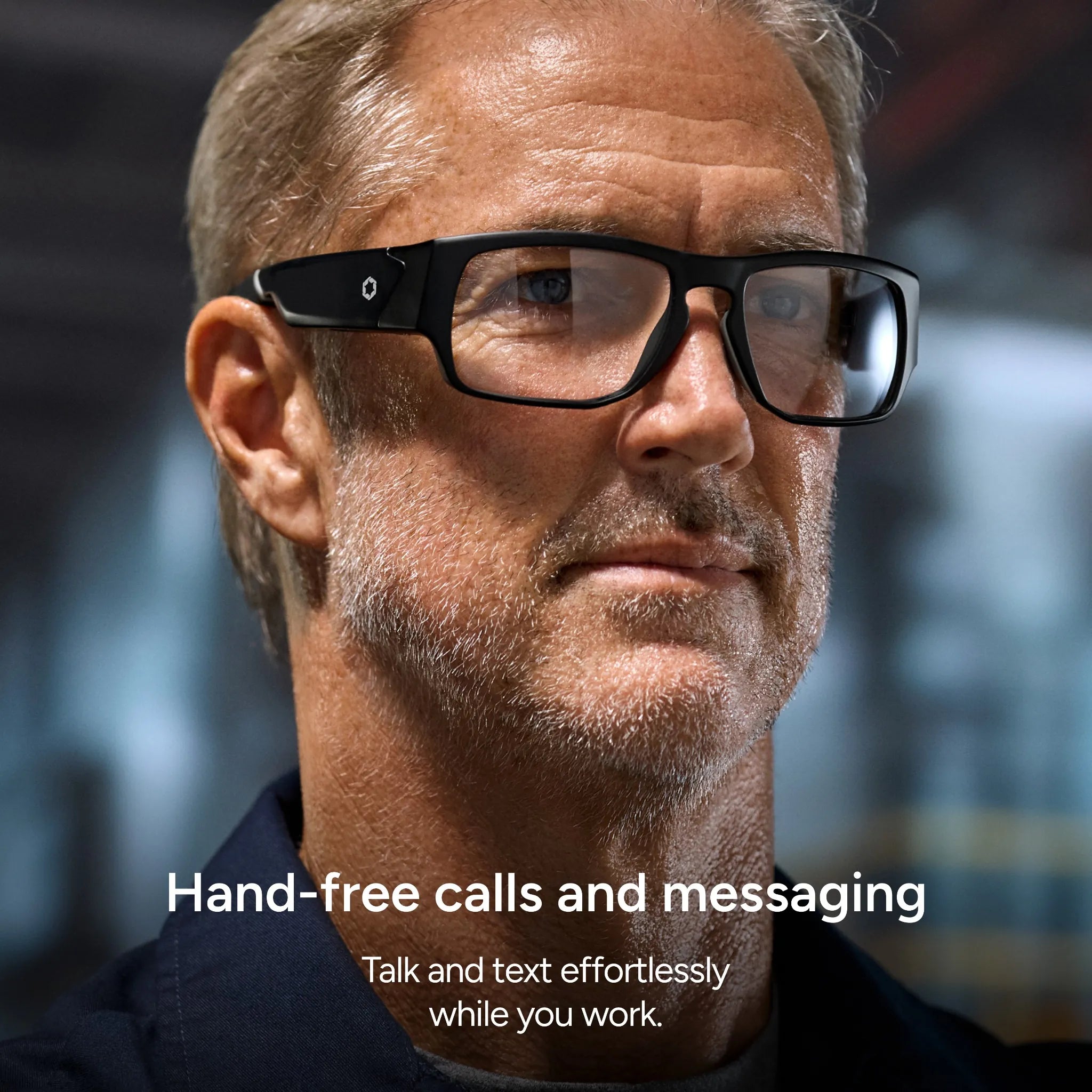 A middle-aged man wears Lucyd Armor | Vantage Photochromic smart safety glasses in an industrial setting. Text: Make hands-free calls and messages easily with Lucyd—talk and text while you work. Prescription-ready.