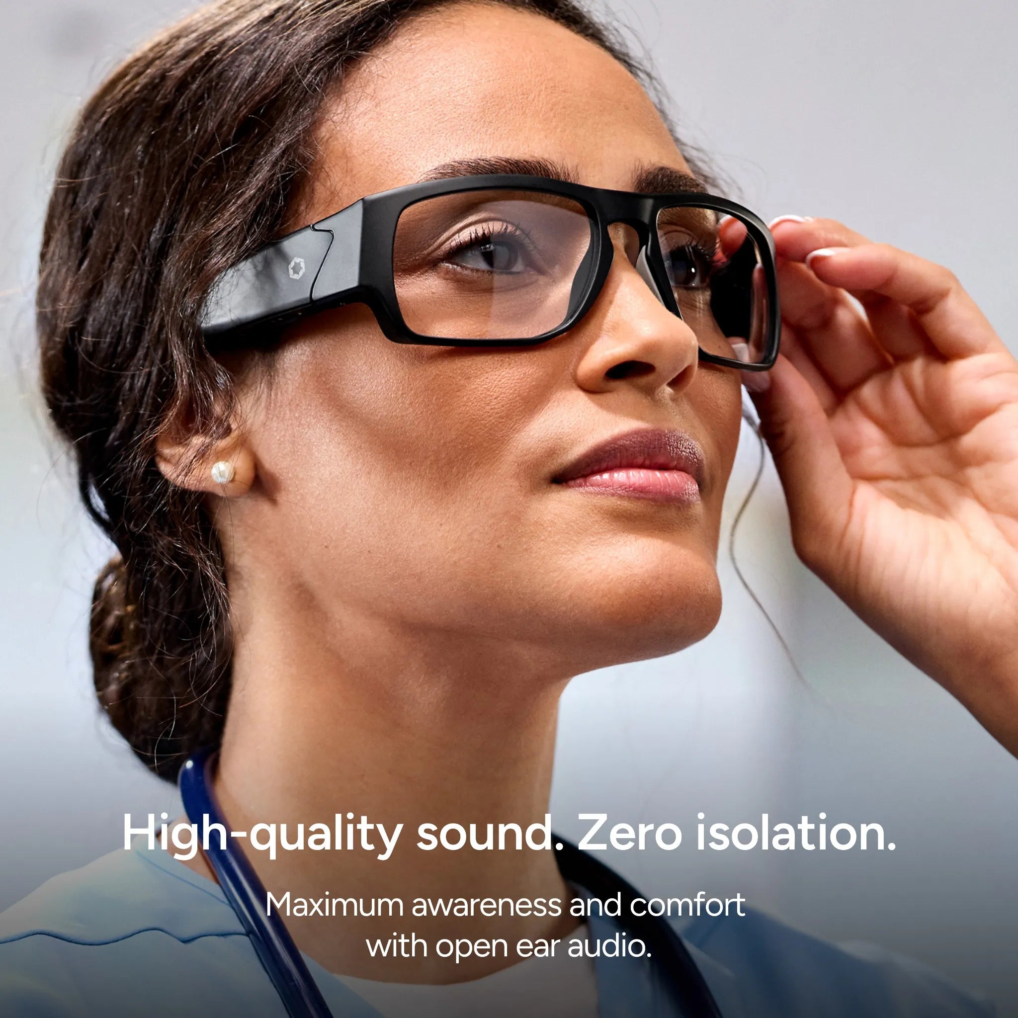 A person wears Lucyd Armor | Vantage Photochromic smart glasses, smiling thoughtfully. Image text: “High-quality sound. Zero isolation. Maximum awareness and comfort with open ear audio by Lucyd.”.