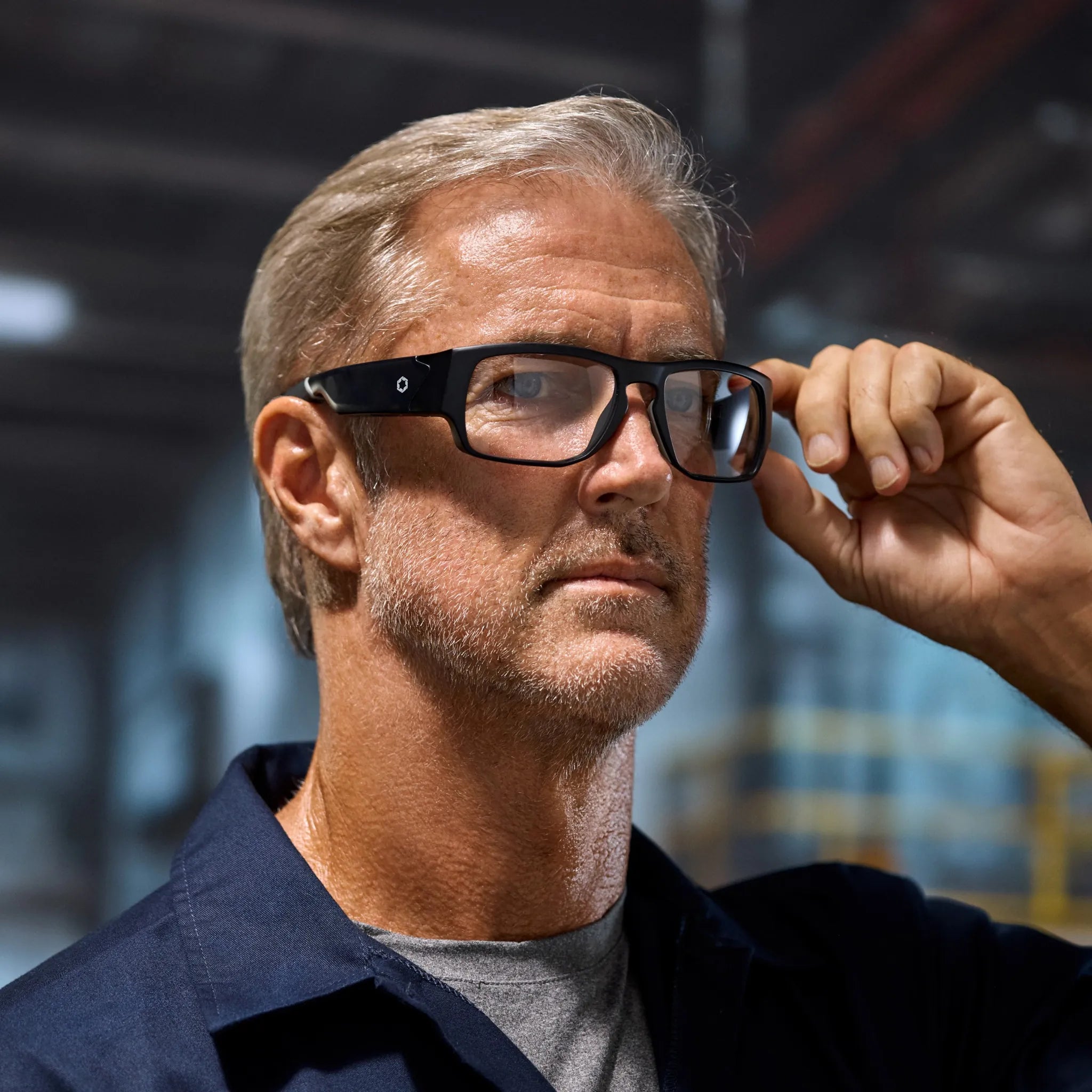 Lucyd Armor | Vantage Photochromic by Lucyd: sleek black wraparound sunglasses with gray photochromic lenses and a simple emblem on the temples, shown on a white background.